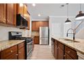 Well-equipped kitchen featuring granite countertops, stainless appliances, and dark-wood cabinetry at 4630 Roseman Trl, Cumming, GA 30040
