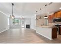Open-concept living area showcasing hardwood floors, fireplace, and large windows for ample natural light at 4630 Roseman Trl, Cumming, GA 30040