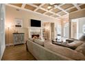 Spacious living room with fireplace, coffered ceilings, and wood floors, creating an elegant and welcoming atmosphere at 492 Thorn Creek Way, Dallas, GA 30157