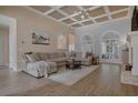Spacious living room with coffered ceilings, hardwood floors, large windows, and cozy seating area at 492 Thorn Creek Way, Dallas, GA 30157