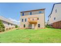 Back exterior view of the home featuring a backyard and an upper level deck at 9183 Golfview Cir, Covington, GA 30014