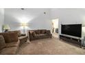 Spacious living room with a comfortable seating arrangement and large television, perfect for relaxation at 161 Aaron Ct, Riverdale, GA 30274