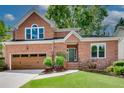 Charming two-story brick home with a well-manicured lawn and a two-car garage at 3007 Frazier Ct, Decatur, GA 30033