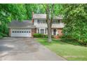 Charming two-story home with a brick and light yellow facade, attached garage, and a well-maintained lawn at 3999 Saint Clair Ne Ct, Brookhaven, GA 30319