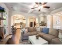 Open-concept living room with hardwood floors, fireplace, and arched doorway to kitchen at 6140 Stillwood Ln, Cumming, GA 30041