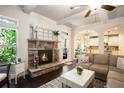 Inviting living room features stone fireplace, hardwood floors, and a view to the kitchen at 6140 Stillwood Ln, Cumming, GA 30041