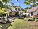Spacious backyard featuring a large deck, patio furniture, and manicured lawn perfect for outdoor living at 122 Griffin Way, Canton, GA 30115