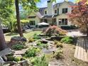A beautiful backyard includes a waterfall and mature trees creating a serene outdoor oasis at 122 Griffin Way, Canton, GA 30115