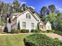 Beautiful home with well-maintained lawn, mature landscaping, and light-colored siding at 122 Griffin Way, Canton, GA 30115