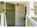 Close-up of the inviting front door with stylish details and a 'Welcome to Kirkwood' sign at 166 Martha Ave, Atlanta, GA 30317