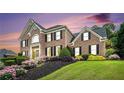 Beautiful brick home with manicured lawn and colorful landscaping at 2258 Bright Water Dr, Snellville, GA 30078