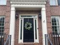 Close-up of elegant front door with decorative wreath and sidelights at 2258 Bright Water Dr, Snellville, GA 30078