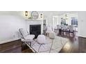 Bright living room with hardwood floors, a fireplace, and an open dining area at 382 Lofton Nw Rd, Atlanta, GA 30309