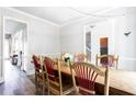 Dining room with a rustic wooden table, chairs, and natural light at 6505 Hampton Creek Dr, Cumming, GA 30041