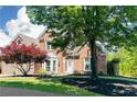 Stunning two-story brick home enhanced by lush landscaping, mature trees and charming curb appeal at 6505 Hampton Creek Dr, Cumming, GA 30041