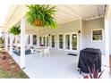Covered patio with outdoor seating, ceiling fans, and a grill, perfect for entertaining at 6505 Hampton Creek Dr, Cumming, GA 30041