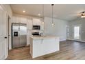 Elegant kitchen features stainless steel appliances, white cabinets, and a functional center island at 80 Hydrangea Cir, Fairburn, GA 30213