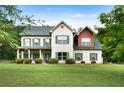 Charming two-story home featuring a brick facade and a spacious well-maintained front yard at 117 Constance Dr, Locust Grove, GA 30248