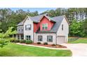 Side view of a charming two-story home featuring a brick facade, a well-maintained lawn and mature landscaping at 117 Constance Dr, Locust Grove, GA 30248