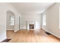 Living room showcasing hardwood floors, a fireplace, and arched doorways for an open feel at 1986 N Decatur Ne Rd, Atlanta, GA 30307