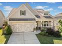 Charming two-story home boasts a manicured lawn and a welcoming front porch at 410 Gardens Of Harmony Dr, Canton, GA 30115