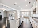 Open kitchen featuring granite countertops, a center island, and stainless steel appliances at 4905 Sterling Close, Buford, GA 30518