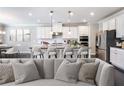 Modern kitchen with stainless steel appliances, white cabinets, and a large island with bar seating at 4905 Sterling Close, Buford, GA 30518
