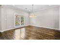 Bright dining room with hardwood floors, modern light fixture and plantation shutters at 505 Ansley Villa Dr, Atlanta, GA 30324