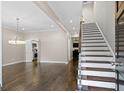 Open living space with hardwood floors and staircase; leads to kitchen and dining at 505 Ansley Villa Dr, Atlanta, GA 30324