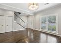 Open living area with sleek staircase, hardwood floors, and natural light at 505 Ansley Villa Dr, Atlanta, GA 30324