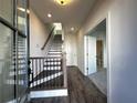 Bright entryway features wood-look flooring, staircase with black railings, and access to a bathroom at 508 Healy Dr # 70, Cumming, GA 30040