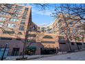 Beautiful brick apartment building features a street view with a garage and blue sky background at 115 W Peachtree Nw Pl # 713, Atlanta, GA 30313