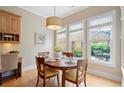 Cozy dining area with natural light, hardwood floors, and views of the private backyard at 11945 Dancliff Trce, Alpharetta, GA 30009