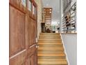 Inviting foyer featuring wood door and staircase leading to upper levels with lots of natural light at 1323 Peachtree Ne Vw, Atlanta, GA 30319