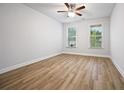 Bright bedroom with hardwood floors and dual windows overlooking a beautiful green view at 730 Lanarck Way, Peachtree City, GA 30269