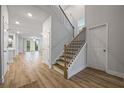 Spacious home foyer featuring hardwood floors, staircase, and entry to living spaces at 730 Lanarck Way, Peachtree City, GA 30269