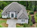 An aerial view of a pristine brick home, surrounded by lush greenery and manicured landscaping at 4216 Tattnall Run, Acworth, GA 30101