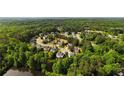 An aerial view shows a neighborhood with mature trees and landscaping at 5015 Preservation Pointe Nw, Kennesaw, GA 30152