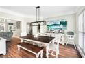 Stylish dining room boasts an oversized dining table, decor, and large windows for natural light at 5015 Preservation Pointe Nw, Kennesaw, GA 30152
