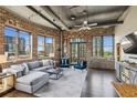 Bright living room features exposed brick, ductwork, and large windows with a cityscape view at 3180 Mathieson Ne Dr # 1001, Atlanta, GA 30305