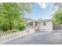 Desirable home featuring lush garden, front yard, private driveway, and a classic white picket fence at 2497 Edwards Nw Dr, Atlanta, GA 30318