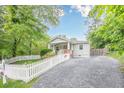 Charming home with manicured lawn, bright flowers, private driveway, and classic white picket fence at 2497 Edwards Nw Dr, Atlanta, GA 30318