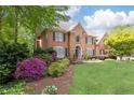 Beautiful two-story brick home featuring lush landscaping and a well-maintained lawn at 93 Ridgetree Ln, Marietta, GA 30068