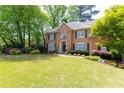 Attractive brick home with a well-manicured lawn and landscaping, creating a welcoming view at 93 Ridgetree Ln, Marietta, GA 30068