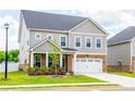 Charming two-story home features brick and gray siding, a two-car garage, and a well-manicured lawn at 13568 Scenic Pkwy, Covington, GA 30014