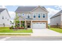 Charming two-story home features brick and gray siding, a two-car garage, and a well-manicured lawn at 13568 Scenic Pkwy, Covington, GA 30014