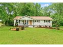 Charming single-story home with a well-manicured front yard and cozy porch at 211 Caboose Ln, Woodstock, GA 30189