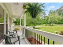 Inviting front porch with chairs and lush landscaping offering a relaxing outdoor space at 211 Caboose Ln, Woodstock, GA 30189