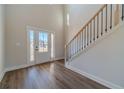 Bright entryway featuring hardwood floors, a staircase, and a front door with glass inserts at 257 Pinewood Dr, Covington, GA 30014