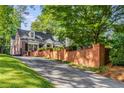 Charming brick home with brick perimeter fence and long driveway at 277 Alberta Ne Dr, Atlanta, GA 30305